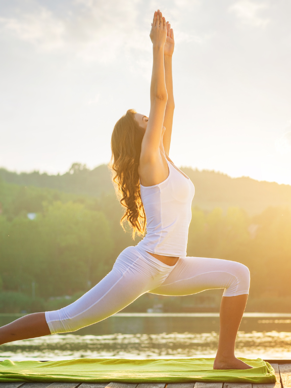 Cancer survivor practicing yoga outdoors under sunlight, symbolising strength, healing, and inner peace.